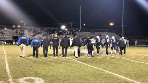 Officer Antwan Toney, a Gwinnett County police officer killed in the line of duty, was honored before South Gwinnett High School’s football game on Nov. 3. Student athletes linked arms with law enforcement officers, and a student read a poem written by South Gwinnett High English Teacher John Leece. CONTRIBUTED