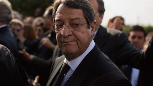 NICOSIA, CYPRUS - NOVEMBER 18: Cyprus President Nicos Anastasiades looks at the coffin of Former Cypriot President Glafcos Clerides as military personnel escort his coffin to a church for his funeral service on November 19, 2013 in Nicosia, Cyprus. The Former President, who oversaw his country's entry into the EU in 2004, died in a Nicosia hospital on Friday evening at the age of 94. (Photo by Andrew Caballero-Reynolds/Getty Images)