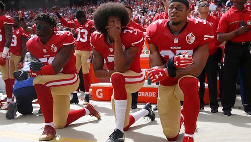 From left, The San Francisco 49ers&apos; Eli Harold (58), Colin Kaepernick (7) and Eric Reid (35) kneel during the national anthem before their a game against the Dallas Cowboys on October 2, 2016, at Levi&apos;s Stadium in Santa Clara, Calif. (Nhat V. Meyer/Bay Area News Group/TNS)