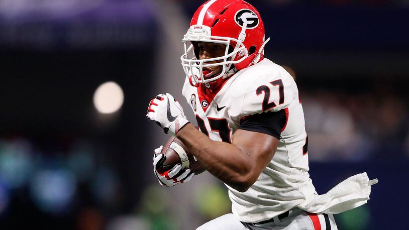 ATLANTA, GA - DECEMBER 02: Nick Chubb #27 of the Georgia Bulldogs runs the ball during the first half against the Auburn Tigers in the SEC Championship at Mercedes-Benz Stadium on December 2, 2017 in Atlanta, Georgia. (Photo by Jamie Squire/Getty Images)