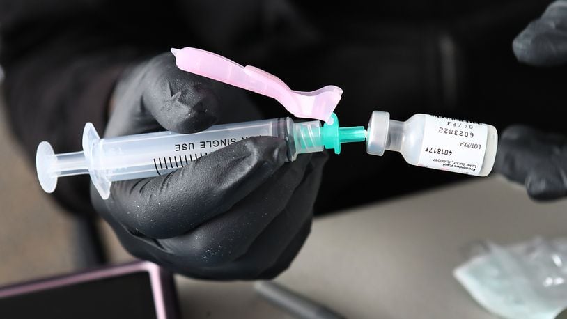 121621 Atlanta: A health care worker prepares a Pfizer booster shot at the Viral Solutions drive-up COVIDd booster vaccinations and testing site on North Druid Hills Road on Thursday, Dec 16, 2021, in Atlanta.  “Curtis Compton / Curtis.Compton@ajc.com”`