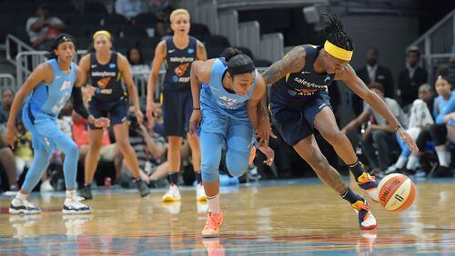June 19, 2019 Atlanta - Atlanta Dream guard Renee Montgomery and Indiana Fever guard Erica Wheeler (right) fight for a loose ball during the second half of WNBA basketball game at State Farm Arena in Atlanta on Wednesday, June 19, 2019. Atlanta Dream won 88-78 over the Indiana Fever. HYOSUB SHIN / HSHIN@AJC.COM