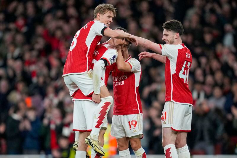Arsenal's Kai Havertz celebrates with teammates after scoring his side's fourth goal during the English Premier League soccer match between Arsenal and Chelsea at Emirates Stadium in London, Tuesday, April 23, 2024. (AP Photo/Kin Cheung)