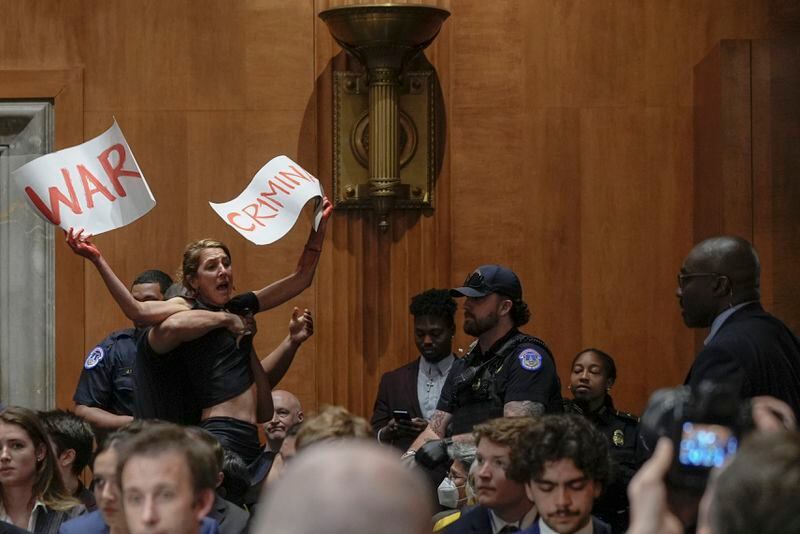 People protest during a Senate Foreign Relations hearing as Secretary of State Antony Blinken, not shown, speaks to examine the President's proposed budget request for fiscal year 2025 for the Department of State, on Capitol Hill, Tuesday, May 21, 2024, in Washington. (AP Photo/Mariam Zuhaib)