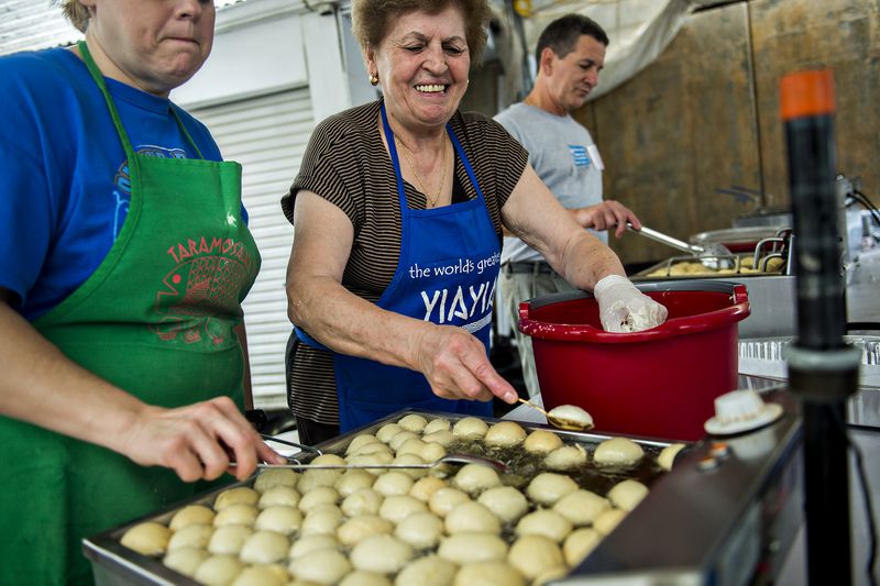 Theoni Giannakopoulos (center) makes fresh loukoumades during the Atlanta Greek Festival at the Greek Orthodox Cathedral of Annunciation on Saturday, September 26, 2015. The weekend long festival features everything Greek from food, shopping, performances, live music and tours of the church. JONATHAN PHILLIPS / SPECIAL