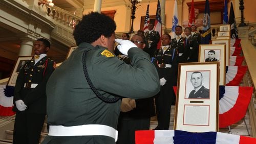Westlake HS Army JROTC member Kedar Leonard salutes the portrait of Air Force Captain Hilliard Willbanks during the ceremony. Veterans, family members and state officials attend a ceremony honoring Medal of Honor recipients from the Vietnam War at the Georgia Capitol Tuesday, March 25, 2014. Twelve Georgians, veterans of the Vietnam War, possess the Medal of Honor. It is the highest accolade this nation gives its warriors. On Tuesday, they were recognized in a special ceremony at the Capitol. Gov. Nathan Deal proclaimed March 29 as Vietnam Veterans Day in Georgia. KENT D. JOHNSON / KDJOHNSON@AJC.COM