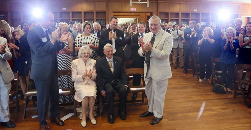 June 26, 2013 - Athens - At the close of the event, Zell Miller (seated), with his wife Shirley by his side,  receives a third standing ovation.   In late June 1993, Gov. Zell Miller bought the first lottery ticket ever sold in Georgia. Today, 20 years later to the day, Miller, Gov. Nathan Deal and other dignitaries gathered at the University of Georgia Zell B. Miller Learning Center for a Lottery 20th Anniversary Ceremony.  BOB ANDRES  / BANDRES@AJC.COM