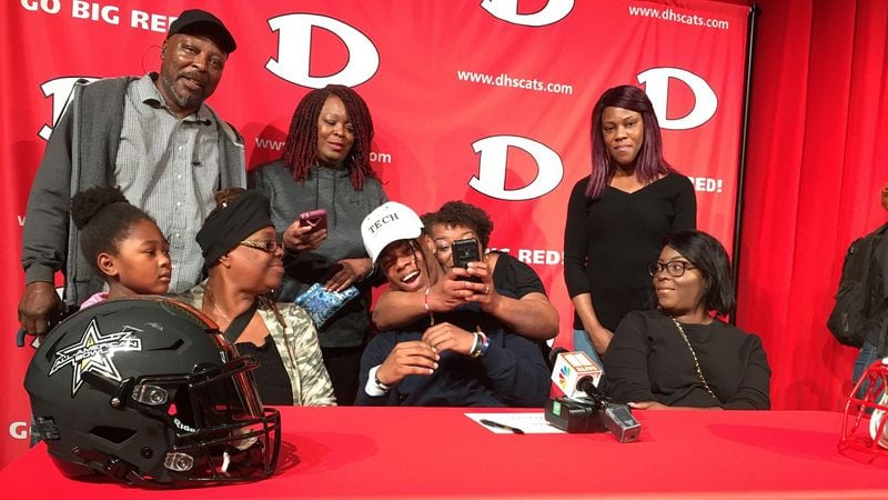 Dalton High running back Jahmyr Gibbs celebrates with family after he announced Wednesday, Feb. 5, 2020 that he will play football for the Georgia Tech Yellow Jackets. (Photo by Ken Sugiura/AJC)