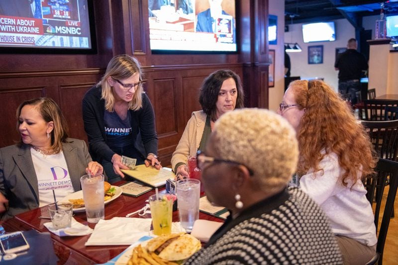 111419 NORCROSSâ€” From left, Denise St. Andrews, President of the Gwinnett Federation of Democratic Women, Penny Bernath, Chair of Campaign Elections, Tracy Sample, Kathleen Kelly and Pinkie Farver, District Director for the Georgia Federation of Democratic Women, gather to watch the presidential debates held in Atlanta Wednesday, November 20, 2019 at Mazzyâ€™s Sports Bar in Norcross, Ga. PHOTO BY ELISSA BENZIE