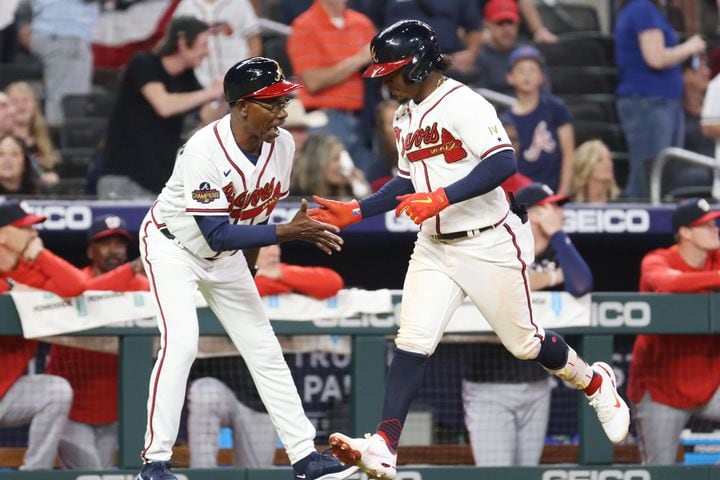 Braves third base coach Ron Washington congratulates Ozzie Albies (1) after hitting a home run in the 8th inning at Truist Park Tuesday, April 12, 2022. Miguel Martinez/miguel.martinezjimenez@ajc.com