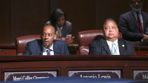 Council member Antonio Lewis, left, speaks next to fellow council member Michael Julian Bond before the council voted 11 to 4 to approve legislation to fund the training center, on Tuesday, June 6, 2023, in Atlanta. Lewis voted against the funding and Bond voted yes. (Jason Getz / Jason.Getz@ajc.com)