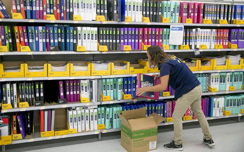 A Walmart associate LeAnna Walters restocks the shelves with binders at a Walmart in Southwest Austin. JAY JANNER / AMERICAN-STATESMAN