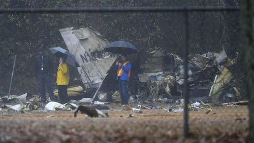 Investigators work the scene of the fatal plane crash. AP Photo/John Amis