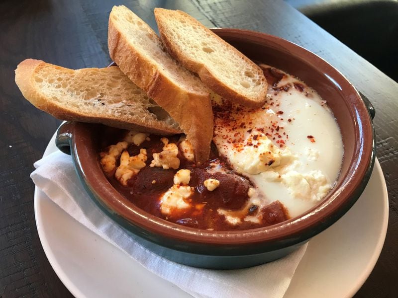 Huevos a la Flamenca at Bar Mercado has a sauce that, for a Spanish dish, is smokier and more heat-laden than expected. LIGAYA FIGUERAS / LFIGUERAS@AJC.COM
