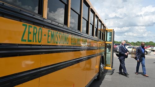 Sen. Raphael Warnock (right) and Phil Horlock, President and CEO of Blue Bird, after a test ride on an electric school bus at one of the company's manufacturing facilities in Fort Valley on Tuesday, May 4, 2021. S(Hyosub Shin / Hyosub.Shin@ajc.com)