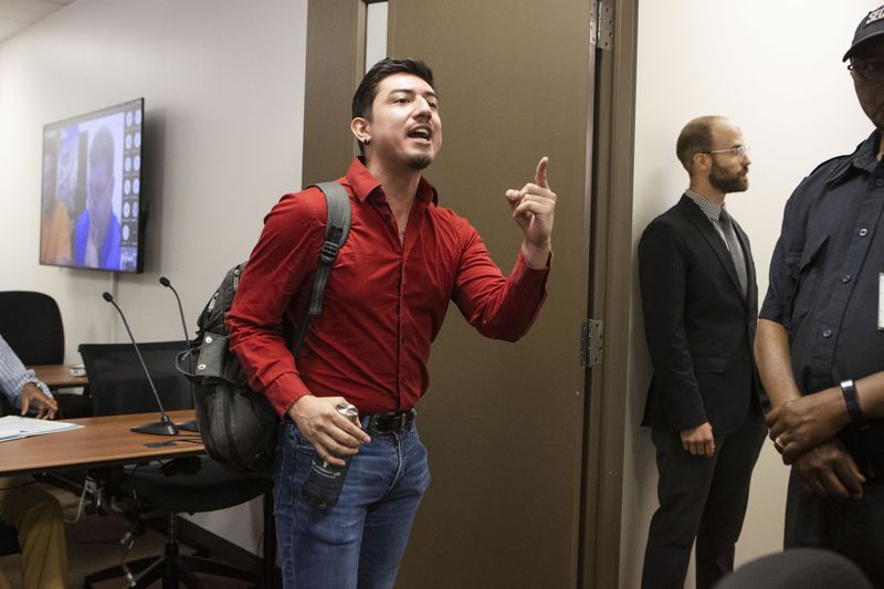 Jonathan Peraza Campos yells at the Georgia Professional Standards commissioners as he walks out of a meeting to consider changes to its educator preparation rules on Thursday, June 8, 2023, at the Georgia Professional Standards Commission boardroom in Atlanta. The commission required members of the public to appear in person to comment though all of the commission attended virtually. CHRISTINA MATACOTTA FOR THE ATLANTA JOURNAL-CONSTITUTION.