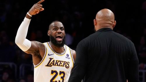 Los Angeles Lakers forward LeBron James, left, asks head coach Darvin Ham for a replay review after he was called for a foul during the second half in Game 4 of an NBA basketball first-round playoff series Saturday, April 27, 2024, in Los Angeles. (AP Photo/Mark J. Terrill)
