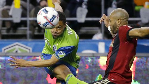 Seattle Sounders midfielder Henry Wingo, left, watches his pass under pressure from Atlanta United defender Tyrone Mears, right, in the second half of an MLS soccer match, Friday, March 31, 2017, in Seattle. The match ended in a 0-0 tie. (AP Photo/Ted S. Warren)