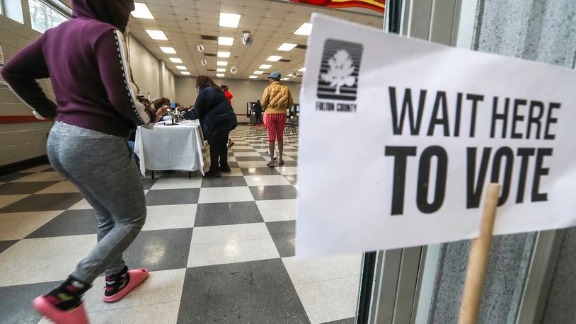 Voters enter on Tuesday, Dec. 6, 2022 at the C.T. Martin Natatorium and Recreation Center located at 3201 M.L.K. Jr Drive SW in Atlanta. (John Spink / John.Spink@ajc.com)