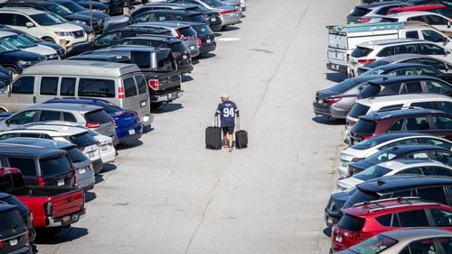 A passenger heads to his car in the nearly full South Economy Parking lot at Hartsfield Jackson International Airport Wednesday, June 22, 2022. Steve Schaefer / steve.schaefer@ajc.com)