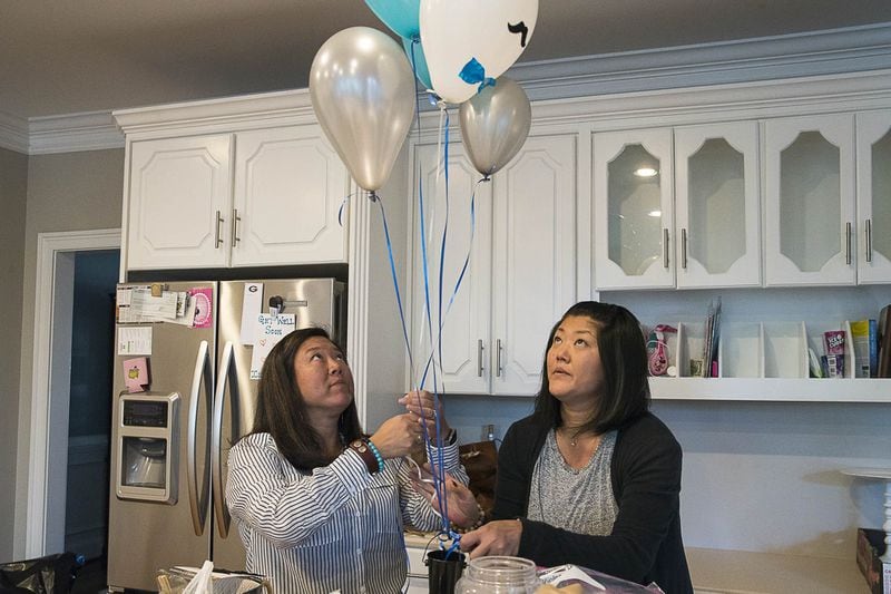 Sisters Jennifer Franz (left) and Janine Dzyubanny work on decorating for a party at a client’s house in Johns Creek. The sisters, who just found each other several months ago, recently started a party planning business, Lucky Penny Party Planners. ALYSSA POINTER / ALYSSA.POINTER@AJC.COM