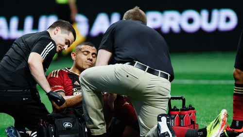 Atlanta United forward Giorgos Giakoumakis (7) gets assistance from the team’s doctors after a play during the first half against the Chicago Fire at Mercedes-Benz Stadium on Sunday, March 31, 2024.
 Miguel Martinez / miguel.martinezjimenez@ajc.com