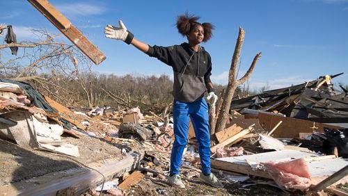 Asiah Bledsoe, sister of Brianna Bledsoe, clears through debris as she looks for a photo of a family member at her grandfather's tornado-wrecked home in Talbotton on Monday, March  4, 2019.  (ALYSSA POINTER/ALYSSA.POINTER@AJC.COM)