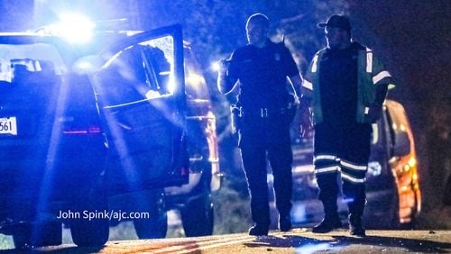 Investigators work the scene of a fatal shooting along Browns Mill Road in the Glenrose Heights neighborhood of southeast Atlanta early Tuesday morning.