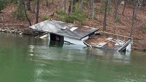 The sinking houseboat "Six Pack Sally" will be removed from Lake Lanier on Oct. 7.