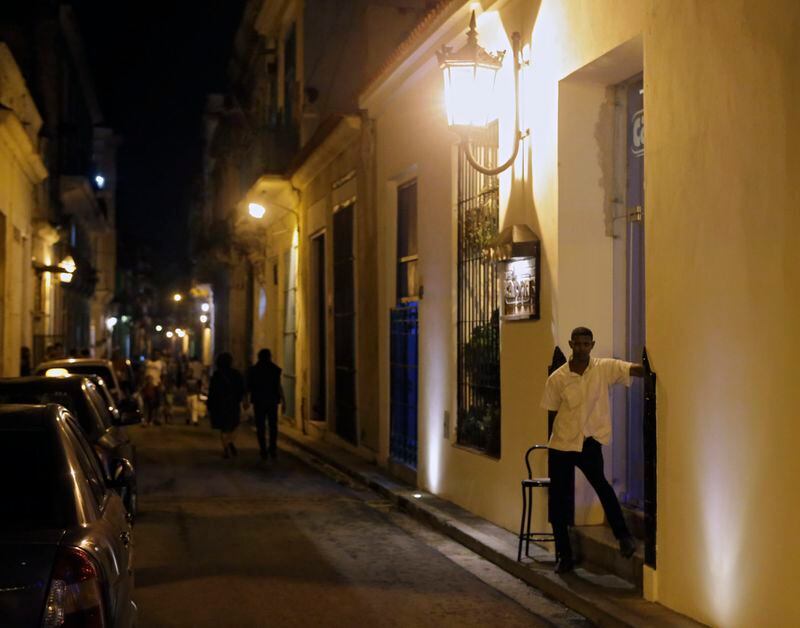 A door man watches outside a restaurant popular with tourists in Havana. The mood was subdued without the nightclub music scene.