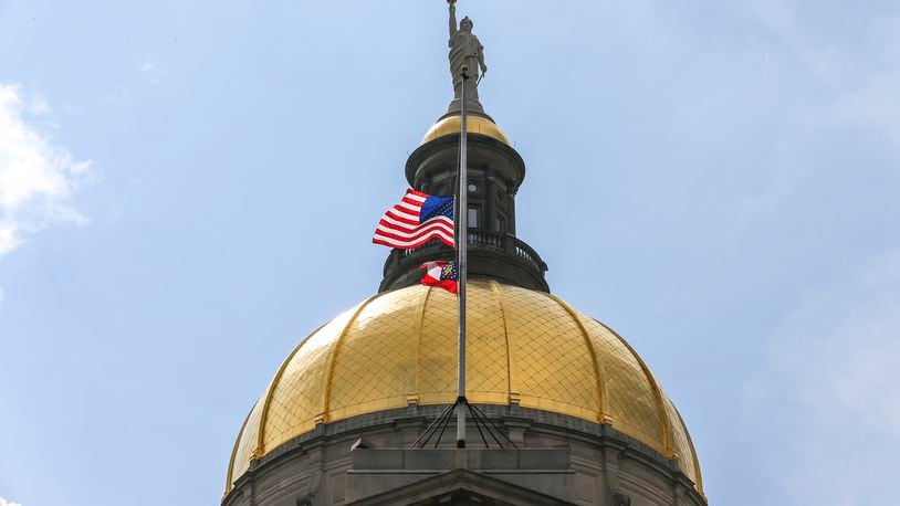 July 11, 2019  Atlanta : The United States and State of Georgia flags flew half-staff at the Georgia State Capitol on Thursday July 11, 2019 after Governor Kemp signed an executive order in memory of Hall County deputy Nicolas Dixon who was shot and killed. JOHN SPINK/JSPINK@AJC.COM