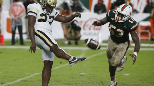 Georgia Tech punter Pressley Harvin III kicks the ball as Miami linebacker Zach McCloud attempts to block during the second half of an NCAA College football game, Saturday, Oct. 14, 2017 in Miami Gardens, Fla. Miami defeated Georgia Tech 25-24. (AP Photo/Wilfredo Lee)
