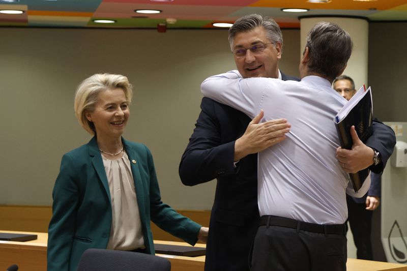 Croatia's Prime Minister Andrej Plenkovic, center, is greeted by Greece's Prime Minister Kyriakos Mitsotakis, right, during a round table meeting at an EU summit in Brussels, Thursday, April 18, 2024. European Union leaders vowed on Wednesday to ramp up sanctions against Iran as concern grows that Tehran's unprecedented attack on Israel could fuel a wider war in the Middle East. (AP Photo/Omar Havana)