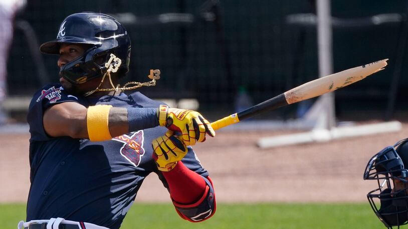 Atlanta Braves' Ronald Acuna Jr. (13) breaks his bat as he pops out in the third inning of a spring training baseball game against the Minnesota Twins, Friday, March 5, 2021, in North Port, Fla. (AP Photo/John Bazemore)
