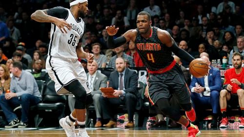Hawks forward Paul Millsap drives to the basket past Nets forward Trevor Booker during their game Sunday, April 2, 2017, in New York. The Nets won 91-82. (AP Photo/Adam Hunger)