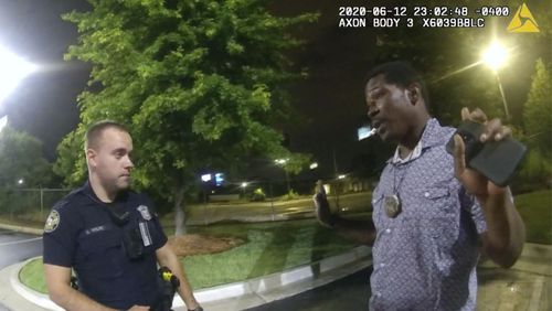 FILE- In this June 12, 2020 file photo from a screen grab taken from body camera video provided by the Atlanta Police Department Rayshard Brooks speaks with Officer Garrett Rolfe in the parking lot of a Wendy's restaurant, in Atlanta. Rolfe has been fired following the fatal shooting of Brooks and a second officer has been placed on administrative duty. The Fulton County District Attorney will announce charging decisions in the fatal shooting of Brooks during a news conference, Wednesday, June 17, 2020 in Atlanta. (Atlanta Police Department via AP, File)