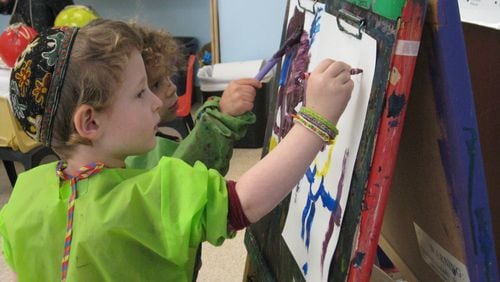Eli Bendicoff (foreground) and Levi Frank work on their artistic creations at the Alefbet Preschool in Dunwoody. A gallery of student work will be on display during an art exhibition on March 31.