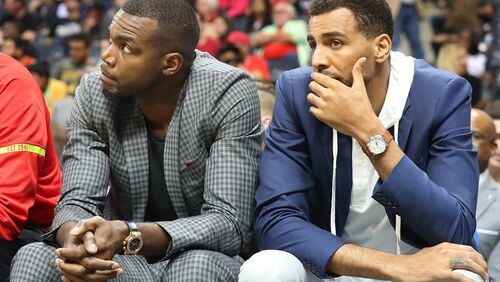 Hawks’ forwards Paul Millsap (left) and Thabo Sefolosha watch a recent game from the bench due to injury. Curtis Compton/ccompton@ajc.com