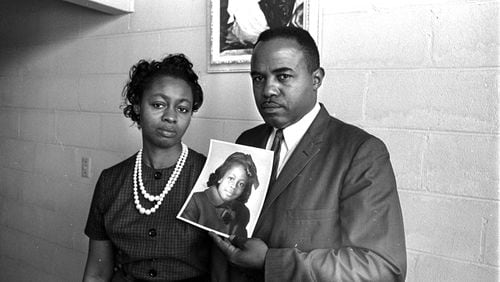 Mr. and Mrs. Chris McNair hold a picture of their daughter, Denise, 11, in Birmingham on Sept. 16, 1963, as they tell a reporter about the bombing of the 16th Street Baptist Church.