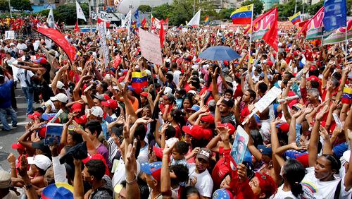 Supporters of Venezuela's President Nicolas Maduro cheer during a rally in Caracas, Venezuela, Thursday, July 27, 2017. Venezuela's President Nicolas Maduro has provoked international outcry and enraged an opposition demanding his resignation with his push to elect an assembly that will rewrite the troubled South American nation's constitution. Sunday's election will cap nearly four months of political upheaval that has left thousands detained and injured and at least 100 dead. (AP Photo/Ariana Cubillos)