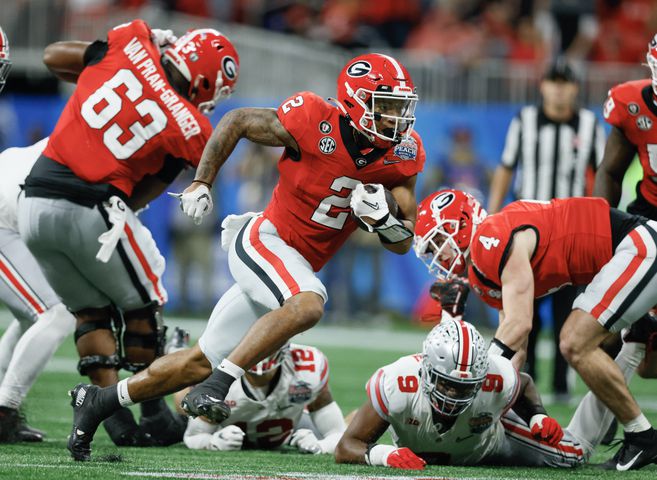 Georgia Bulldogs running back Kendall Milton (2) gains 15 yards on a drive that resulted in a field goal during the second quarter of the College Football Playoff Semifinal between the Georgia Bulldogs and the Ohio State Buckeyes at the Chick-fil-A Peach Bowl In Atlanta on Saturday, Dec. 31, 2022. (Jason Getz / Jason.Getz@ajc.com)