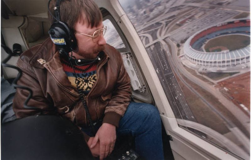 Traffic reporter, Herb Emory, from WSB Radio, giving a traffic report from a helicopter. Atlanta-Fulton County Stadium sits in the background, Atlanta, Georgia, January 3, 1994. AJC FILE PHOTO