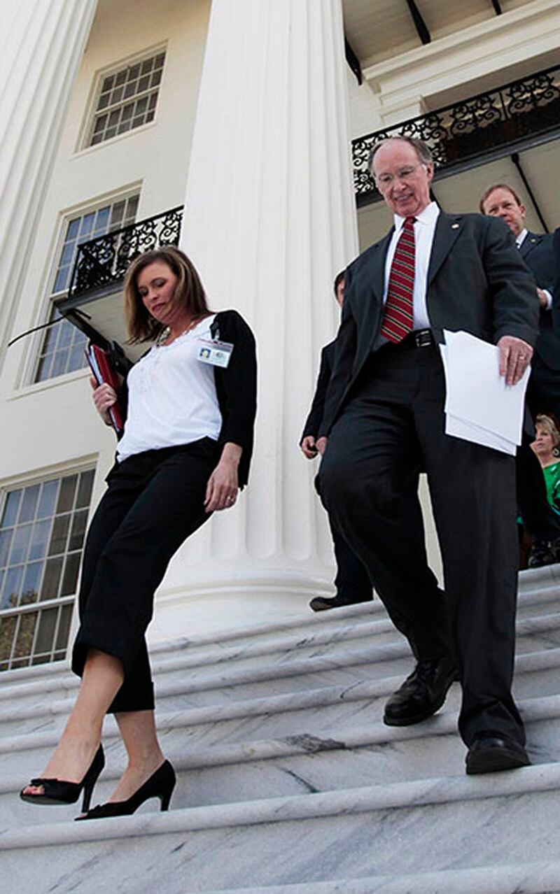 FILE -In this Tuesday, March 22, 2011 file photo Alabama Gov. Robert Bentley, center, arrives for a news conference at the Alabama Capitol in Montgomery, Ala. At left is Rebekkah Mason, Bentley's Communications Director. Bentley admitted Wednesday, March 23, 2016, that he made inappropriate remarks to his senior political adviser, Rebekah Caldwell Mason. Bentley said he did not have a sexual relationship with Mason, but he apologized to his family and Mason's for his behavior. (AP Photo/Dave Martin, File)