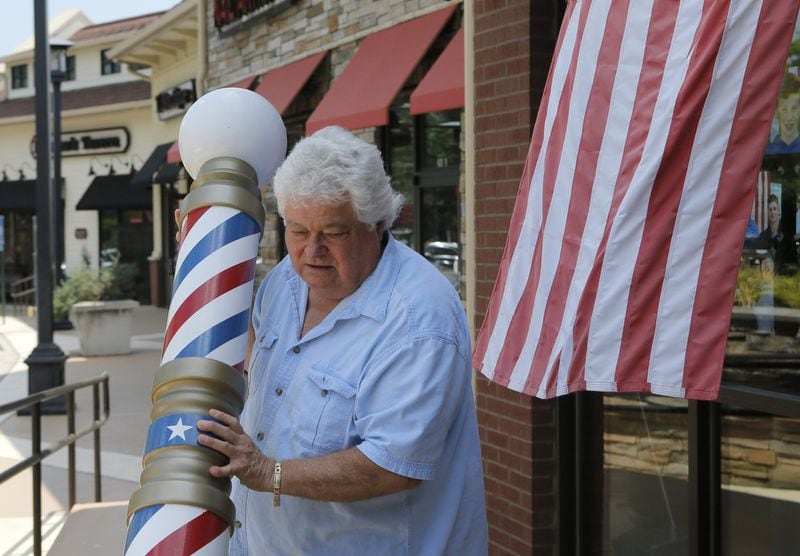 April 20, 2017 - Johns Creek - Tony Rainieri, who operates a barbershop in Johns Creek, rolls his barber pole outside the store every day. Voters in the Johns Creek area of Georgia’s Sixth Congressional district. BOB ANDRES /BANDRES@AJC.COM