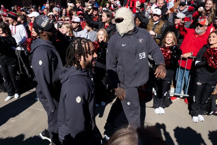 UGA’s Broderick Jones wears a furry ski mask on the Dawg Walk before the UGA football celebration Saturday, Jan. 14, 2023 in Athens. Ben Gray for the Atlanta Journal-Constitution