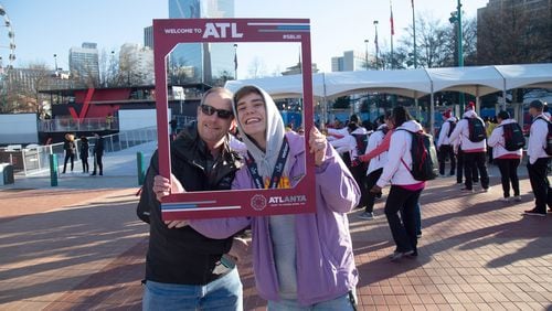 Doug Brown and his son Ethan get their photo taken after entering the Super Bowl LIVE presented by Verizon at the Centennial Olympic Park in downtown Atlanta January 31, 2019.  STEVE SCHAEFER / SPECIAL TO THE AJC