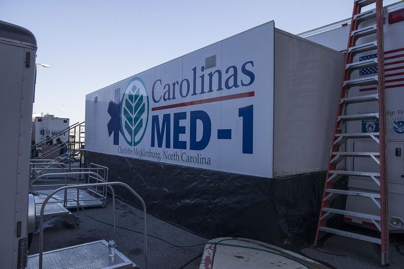 The exterior of Carolinas MED-1 (right), a mobile medical facility located outside of the Marcus trauma and emergency room at Grady Memorial Hospital in Atlanta. (ALYSSA POINTER/ALYSSA.POINTER@AJC.COM)
