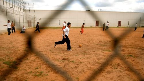 Detainees playing soccer at Stewart Detention Center, a holding facility for immigrants being processed for deportation. (JOEY IVANSCO/staff photo).