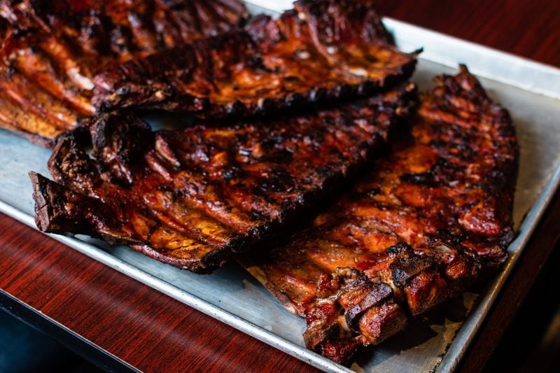 A tray full of ribs fresh out of the pit at Dreamland in Duluth’s Parsons Alley, delivered by pitmaster Raymon Dennis, who said, "I love my job." CONTRIBUTED BY HENRI HOLLIS