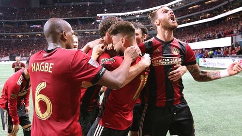 Atlanta United players mob Hector Villalba after his goal for a 3-0 victory over the New York Red Bulls during the second half in their Eastern Conference finals MLS soccer game on Sunday, Nov. 25, 2018, in Atlanta.   Curtis Compton/ccompton@ajc.com